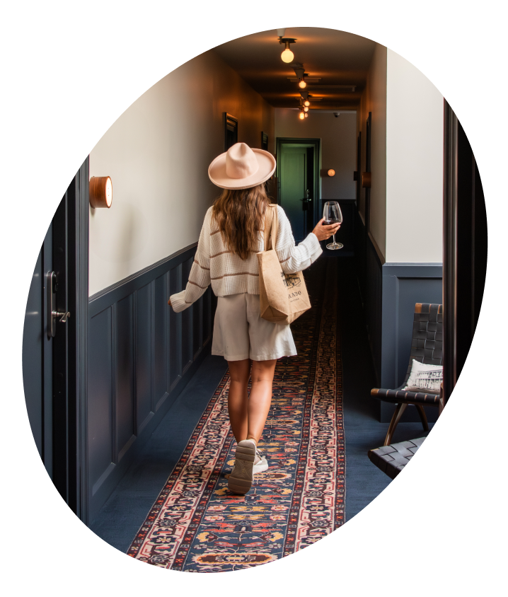 Woman Walking down hallway with wine